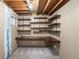 Unfinished basement featuring a built-in desk and shelving at 11525 Eaton Ct, Westminster, CO 80020