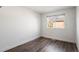 Bright bedroom with wainscotting, featuring a window view, and modern flooring at 11525 Eaton Ct, Westminster, CO 80020