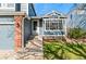 Charming home entrance showcasing a well-manicured lawn and brick detailing on a sunny day at 11525 Eaton Ct, Westminster, CO 80020