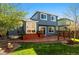 Exterior of house with wooden deck, sliding glass doors, and a lush lawn at 11525 Eaton Ct, Westminster, CO 80020
