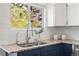 Classic kitchen features white subway tile backsplash, granite countertops and views of the green outdoors at 11525 Eaton Ct, Westminster, CO 80020