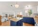 Eat-in kitchen with blue cabinetry, stone countertops and bright, natural light from the sliding doors at 11525 Eaton Ct, Westminster, CO 80020