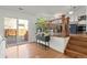 Bright open concept main living area showing hardwood floors, deck access and a staircase at 11525 Eaton Ct, Westminster, CO 80020