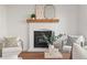Cozy fireplace as a focal point with chairs and a modern wooden mantle with decor at 11525 Eaton Ct, Westminster, CO 80020