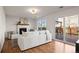 Inviting living room featuring white sofa, fireplace, and access to an outdoor deck at 11525 Eaton Ct, Westminster, CO 80020