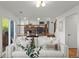 Open-concept living room with steps leading up to the kitchen and sliding door accessing the deck at 11525 Eaton Ct, Westminster, CO 80020