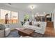 Bright living room with large windows, white sofa, and seamless flow into the kitchen area at 11525 Eaton Ct, Westminster, CO 80020