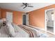 Spacious main bedroom with neutral tones, warm wood flooring, and convenient access to the en-suite bathroom at 11525 Eaton Ct, Westminster, CO 80020