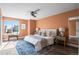 Serene main bedroom with large windows, plush bedding, ceiling fan, and stylish decor at 11525 Eaton Ct, Westminster, CO 80020
