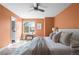 Bright main bedroom featuring natural light, cozy bedding, a modern ceiling fan, and tasteful accents at 11525 Eaton Ct, Westminster, CO 80020