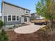The backyard has an inviting patio with outdoor seating and lush landscaping at 9446 Quintero St, Commerce City, CO 80022