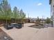 The backyard has an inviting patio with outdoor seating and lush landscaping at 9446 Quintero St, Commerce City, CO 80022