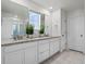 Bathroom features a dual sink vanity with granite counters and ample cabinet space at 9446 Quintero St, Commerce City, CO 80022