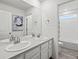 Elegant bathroom features double sinks with plenty of counter space and a view into the pristine, bright shower at 9446 Quintero St, Commerce City, CO 80022
