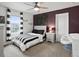Stylish bedroom with modern decor, a striking accent wall, and ample natural light for a relaxing retreat at 9446 Quintero St, Commerce City, CO 80022
