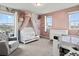 Charming bedroom features a crib, floral wallpaper, dresser, and large windows with plenty of natural light at 9446 Quintero St, Commerce City, CO 80022