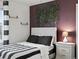 Stylish bedroom with modern decor, a striking accent wall, and ample natural light for a relaxing retreat at 9446 Quintero St, Commerce City, CO 80022