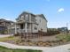 A view of this two-story home showing a fenced yard with natural landscaping at 9446 Quintero St, Commerce City, CO 80022
