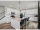 Kitchen with large island, granite counters, stainless appliances, and modern lighting at 9446 Quintero St, Commerce City, CO 80022
