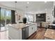 Open concept kitchen features granite counters, stainless steel appliances, and hardwood floors at 9446 Quintero St, Commerce City, CO 80022