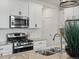 Bright kitchen showcasing stainless steel appliances and granite countertops at 9446 Quintero St, Commerce City, CO 80022