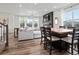 Open-concept living area with modern decor, wood floors, and a large window offering natural light at 9446 Quintero St, Commerce City, CO 80022