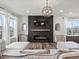 Open-concept living room showcases a fireplace and modern decor for a welcoming atmosphere at 9446 Quintero St, Commerce City, CO 80022