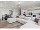 Large sectional sofa in a combined living and dining area provides a spacious layout at 9446 Quintero St, Commerce City, CO 80022