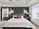 Main bedroom boasts an accent wall, a tray ceiling, and large windows at 9446 Quintero St, Commerce City, CO 80022