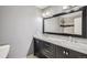 Modern bathroom with double sinks, a large mirror, and a stylish vanity at 1818 S Quebec Way # 11-8, Denver, CO 80231