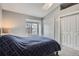 Cozy bedroom featuring a window, closet, and a comfortable bed at 1818 S Quebec Way # 11-8, Denver, CO 80231