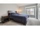 Comfortable bedroom with a bed, nightstand and a window, providing a relaxing atmosphere at 1818 S Quebec Way # 11-8, Denver, CO 80231