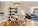 Bright dining area showcasing a stylish table and shelving unit, with views into the living room at 1818 S Quebec Way # 11-8, Denver, CO 80231