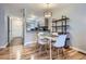 Cozy dining area with modern table and chairs, adjacent to the kitchen, and a decorative shelf at 1818 S Quebec Way # 11-8, Denver, CO 80231