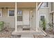 Charming front entrance with a white door, pillars, and a well-kept porch in a quiet neighborhood at 1818 S Quebec Way # 11-8, Denver, CO 80231
