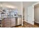 Open kitchen view with a granite countertop, stainless steel appliances, and view into the living area at 1818 S Quebec Way # 11-8, Denver, CO 80231
