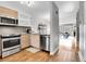Modern kitchen with stainless steel appliances, stylish cabinets, and sleek countertops, seamlessly flowing into the living area at 1818 S Quebec Way # 11-8, Denver, CO 80231