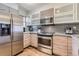 Modern kitchen featuring stainless steel appliances, granite countertops, and elegant cabinetry at 1818 S Quebec Way # 11-8, Denver, CO 80231