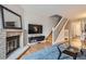 Inviting living room featuring a brick fireplace, TV, and stylish decor at 1818 S Quebec Way # 11-8, Denver, CO 80231
