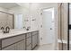 Sleek bathroom with double vanity, quartz countertop and a shower at 14123 Deertrack Ln, Parker, CO 80134