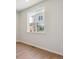 Bedroom with wood flooring and a large window providing ample natural light at 14123 Deertrack Ln, Parker, CO 80134
