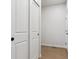 Hallway featuring white doors, wood flooring, and natural light at 14123 Deertrack Ln, Parker, CO 80134