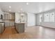 Spacious kitchen and living area with gray cabinets, stainless appliances, and wood flooring at 14123 Deertrack Ln, Parker, CO 80134