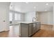 Kitchen island boasts a sink, dishwasher, and gray cabinets in an open floor plan at 14123 Deertrack Ln, Parker, CO 80134
