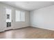 Bright living room with wood flooring, large windows, and a door to the outside at 14123 Deertrack Ln, Parker, CO 80134
