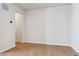 Neutral room with laminate floors, white walls, and a modern thermostat at 14123 Deertrack Ln, Parker, CO 80134