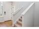 Staircase with carpeted steps and white handrails leads to the upper level at 14123 Deertrack Ln, Parker, CO 80134