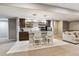 Finished basement bar area with stylish cabinetry, counter seating, and modern appliances at 16201 Lanceleaf Pl, Parker, CO 80134