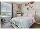 Charming bedroom featuring a large window, soft colors, decorative accents, and ample natural light at 16201 Lanceleaf Pl, Parker, CO 80134