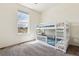 Bright bedroom showcasing a white bunk bed with blue bedding, a window with views and neutral carpeting at 16201 Lanceleaf Pl, Parker, CO 80134